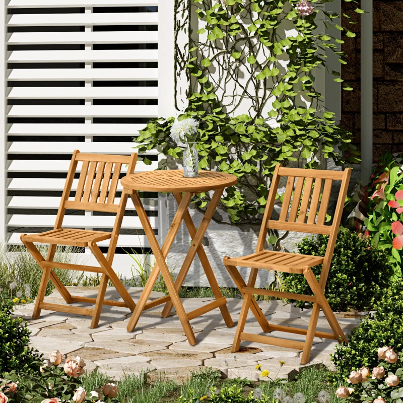 Wooden bistro set with two chairs and a round table in a lush green garden corner.

