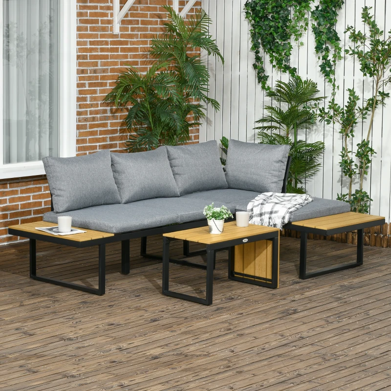 Gray aluminum sectional patio sofa with cushions and matching coffee tables on wooden deck with plants.