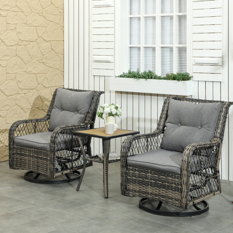 Two gray wicker swivel patio chairs with matching table near windowed wall and potted plants.