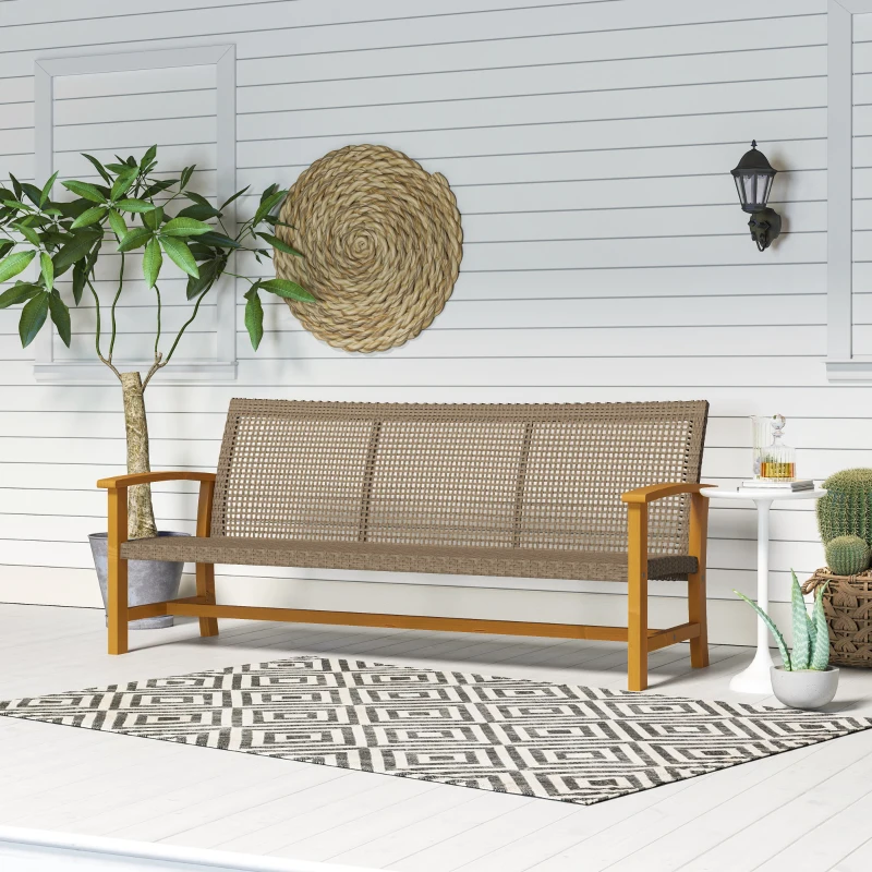 Three-seat outdoor wicker sofa with wooden frame placed on a white porch beside plants and décor.