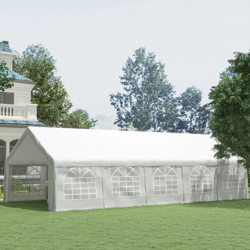 White event canopy tent set up on grassy backyard lawn.
