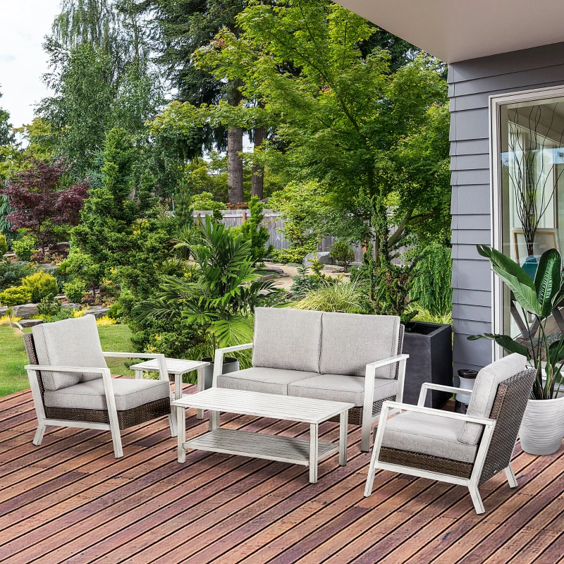 Gray aluminum outdoor sectional sofa set with wooden tables on a patio deck surrounded by greenery.
