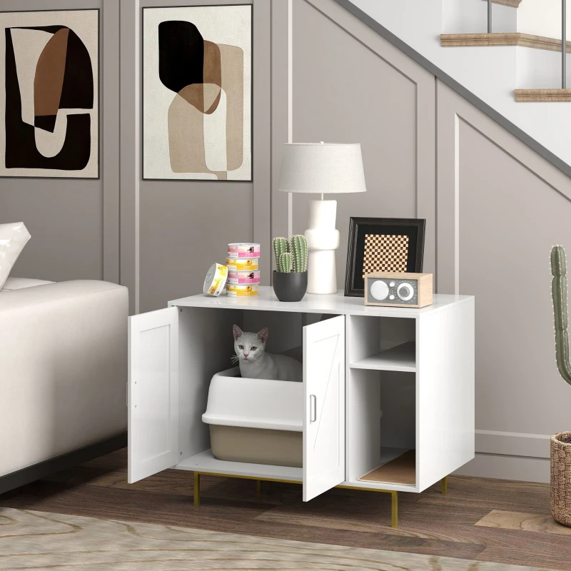 White cat sitting in litter box inside white cabinet beside sofa.
