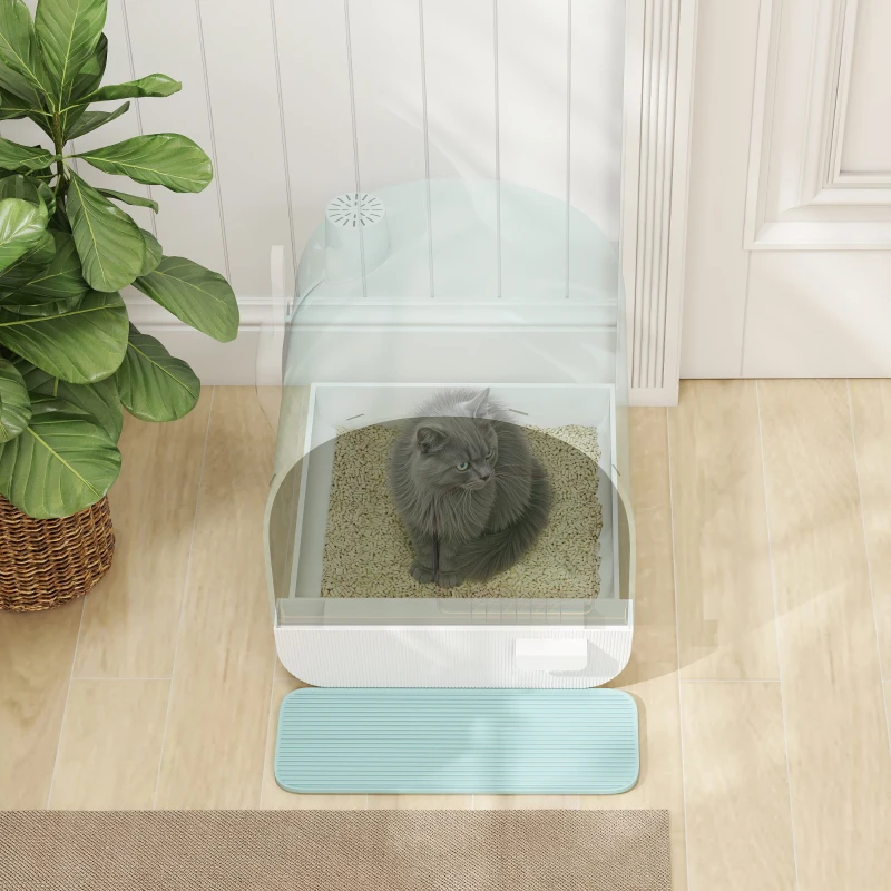 Grey cat sitting inside covered white litter box on wooden floor.
