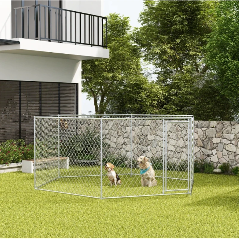 Two dogs sitting inside a spacious chain-link kennel placed on green grass.