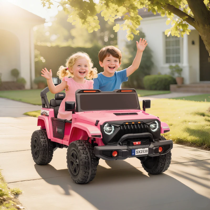 Two kids smiling and driving pink toy jeep on sunny driveway.
