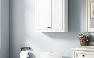 White wall-mounted bathroom cabinet with double doors above toilet and sink.
