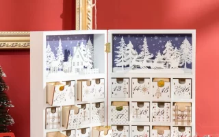 Open wooden advent calendar with white forest design.