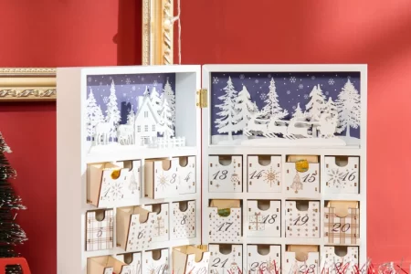 Open wooden advent calendar with white forest design.