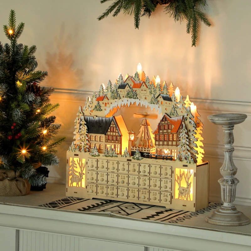 Illuminated wooden advent calendar featuring snowy village houses and Christmas trees.