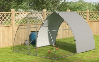 Walk-in metal dome chicken run enclosure with wire mesh and sun shade in a green yard.
