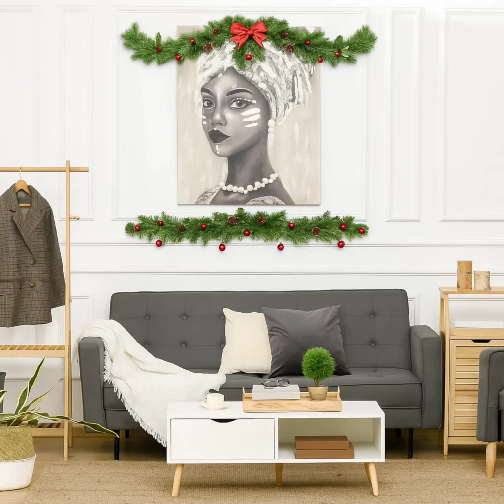Festive wall art framed with garlands displayed above a modern sofa in a decorated living room.
