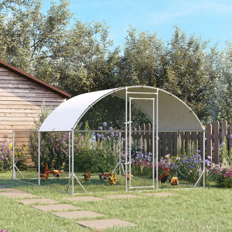 Backyard view of a large dome-shaped, walk-in metal chicken run with a sun cover.