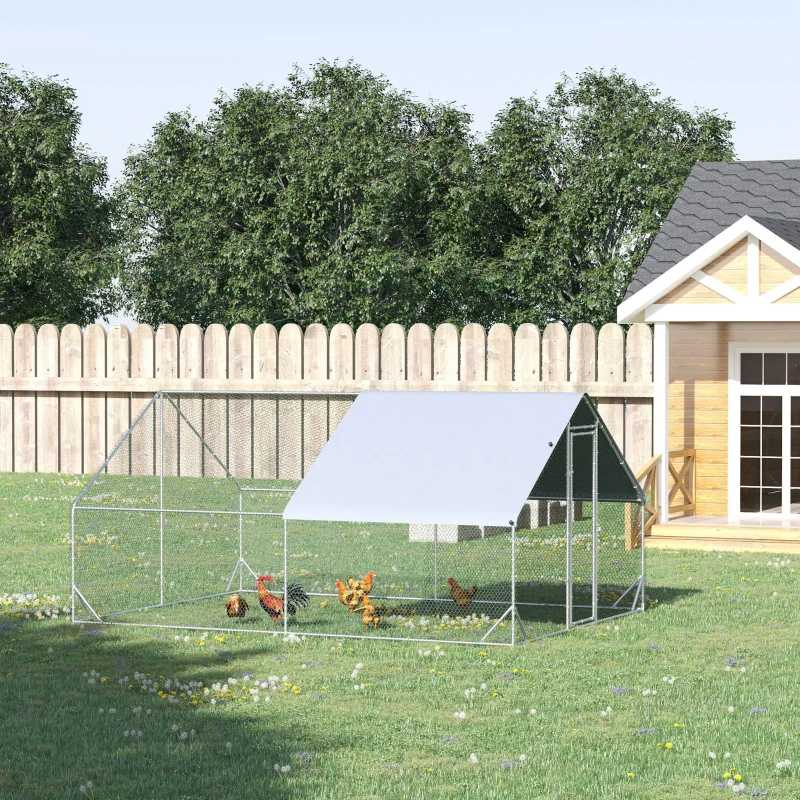 Walk-in metal chicken run with a sun and rain protective cover in a grassy backyard.
