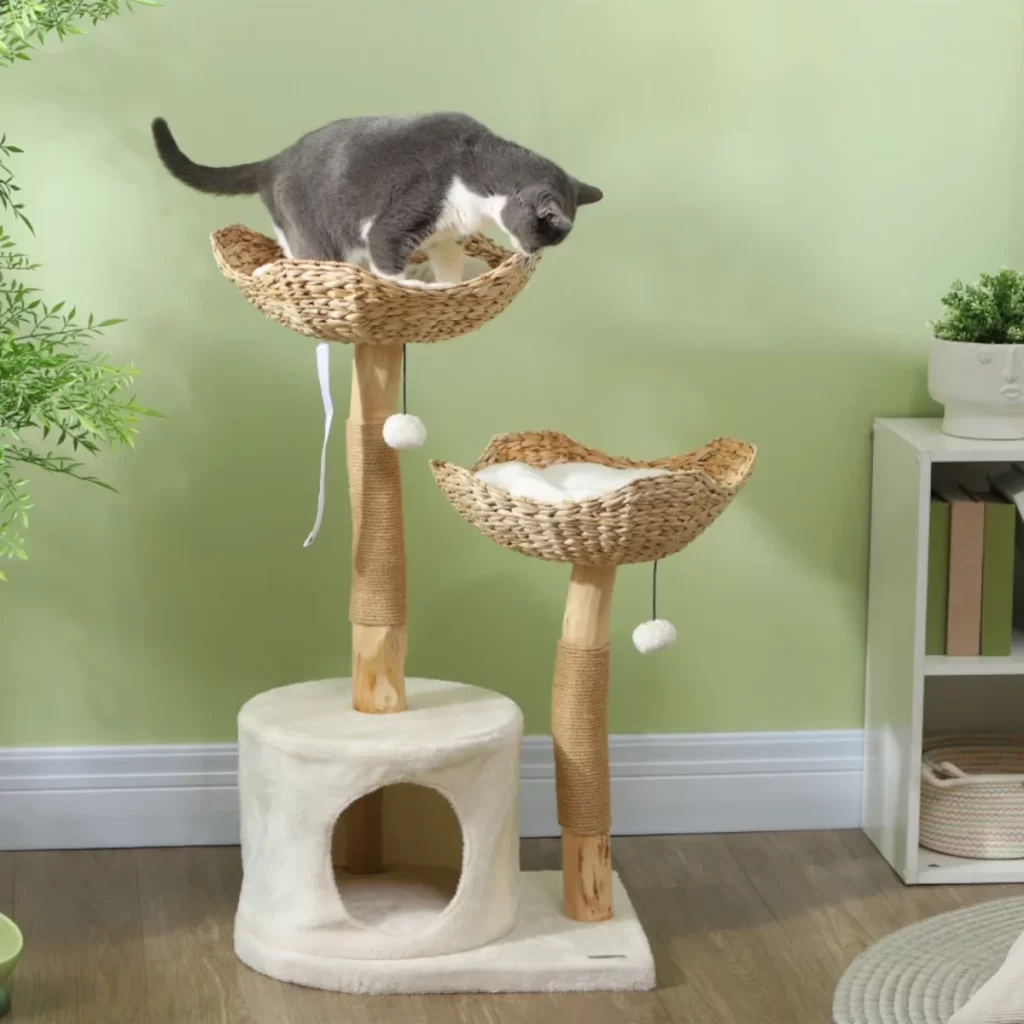 Tall pink and green cat tree with three cats resting on different platforms.